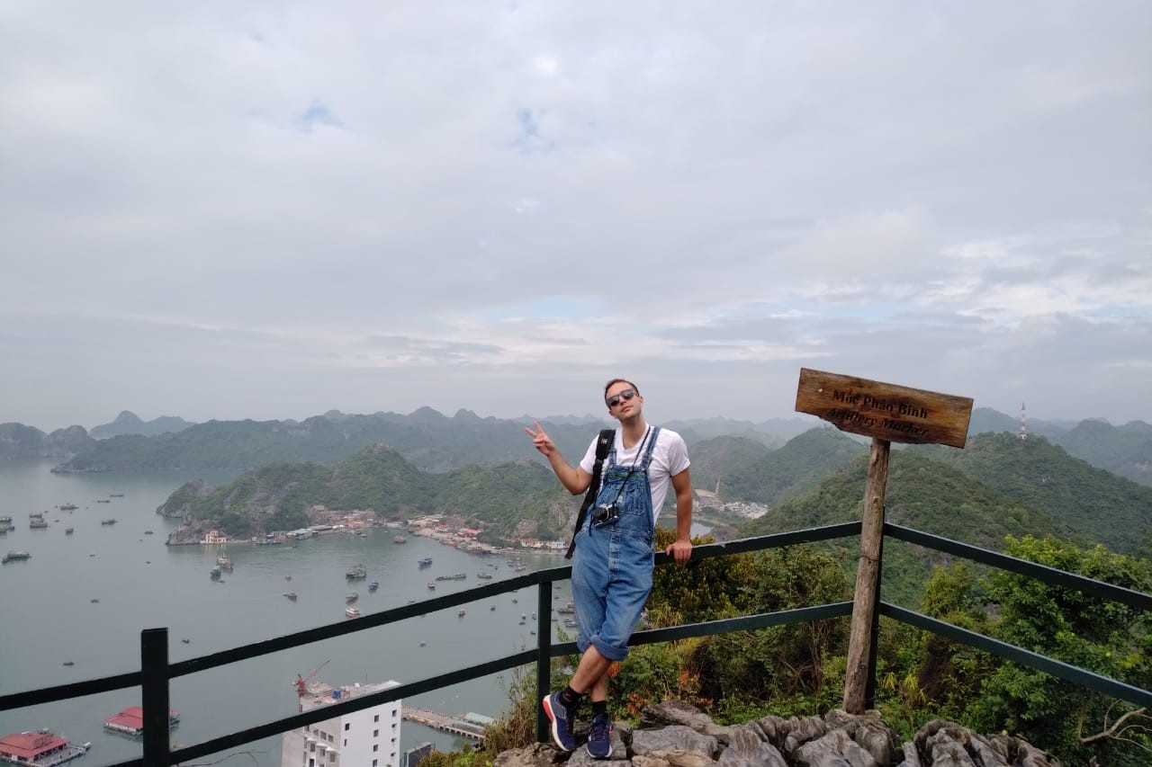 Eric Ardman in front of mountain range backdrop in Vietnam.